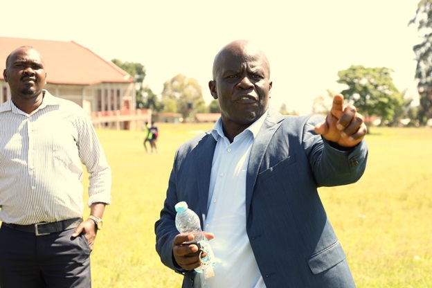 Peter Bukhala instructing an athlete on the pitch